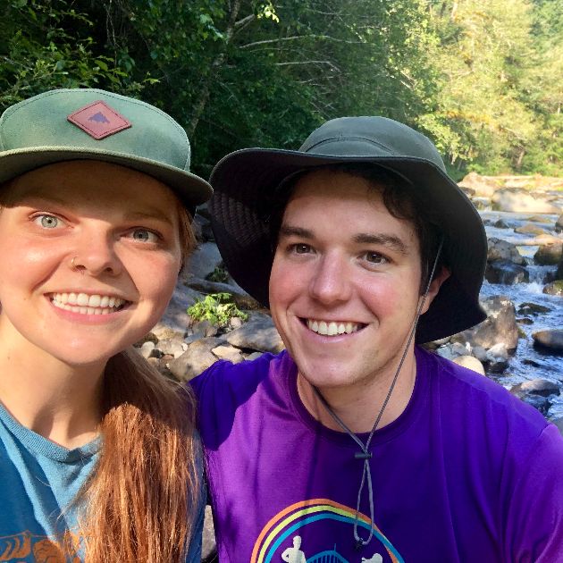 Lisa and Paul smiling by a river